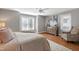 Relaxing bedroom featuring neutral walls, hardwood floors, ceiling fan and a comfy sitting chair at 115 Ripplewater Ln, Cary, NC 27518