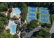 Aerial view of community pools, tennis courts, and clubhouse surrounded by mature trees at 115 Ripplewater Ln, Cary, NC 27518