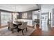Dining room boasts stylish chandelier, modern furniture, and gray paneled walls at 115 Ripplewater Ln, Cary, NC 27518