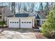 Charming gray home featuring a two-car garage, dormers, and a professionally landscaped yard at 115 Ripplewater Ln, Cary, NC 27518