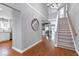Bright foyer with hardwood floors, a staircase, and a view into other living spaces at 115 Ripplewater Ln, Cary, NC 27518
