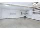 Spacious garage with epoxy flooring, cabinets and storage shelves at 115 Ripplewater Ln, Cary, NC 27518