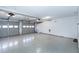 Spacious two car garage featuring an epoxy floor and two garage doors at 115 Ripplewater Ln, Cary, NC 27518