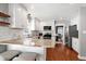Well-lit kitchen with granite countertops, white cabinets, and stainless steel appliances at 115 Ripplewater Ln, Cary, NC 27518