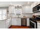 Updated kitchen featuring stainless steel appliances, granite counters, and ample cabinet space at 115 Ripplewater Ln, Cary, NC 27518