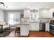 Open concept kitchen with breakfast bar, stainless steel appliances and adjacent dining area at 115 Ripplewater Ln, Cary, NC 27518