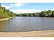 Beautiful lake view with a walking path and lush greenery providing a serene natural backdrop at 115 Ripplewater Ln, Cary, NC 27518