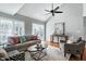 Living room with vaulted ceiling, ceiling fan, neutral walls, modern furniture, and hardwood flooring at 115 Ripplewater Ln, Cary, NC 27518