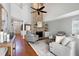 Living room with a large stone fireplace, vaulted ceilings, and hardwood flooring at 115 Ripplewater Ln, Cary, NC 27518