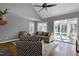 Bright living room with vaulted ceiling, ceiling fan, and view to sunroom through large sliding glass door at 115 Ripplewater Ln, Cary, NC 27518