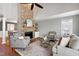 Spacious living room with a large stone fireplace, vaulted ceilings, and hardwood flooring at 115 Ripplewater Ln, Cary, NC 27518