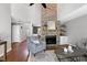 Living room boasts a large stone fireplace, vaulted ceilings, and hardwood flooring at 115 Ripplewater Ln, Cary, NC 27518