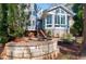 Back of home featuring a sunroom, paver patio, and manicured landscaping at 115 Ripplewater Ln, Cary, NC 27518