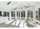 Sunroom filled with natural light boasts a skylight, arched windows, and neutral color palette at 115 Ripplewater Ln, Cary, NC 27518