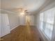 Bright bedroom featuring hardwood floors, neutral walls, and a sliding barn door at 11928 Straight A Way Ln, Raleigh, NC 27613