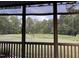 Beautiful screened porch view of a large grassy backyard extending into a lush green forest at 127 Lakemont Dr, Clayton, NC 27520