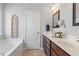 Bright bathroom featuring a double sink vanity, framed mirrors, and a soaking tub at 127 Lakemont Dr, Clayton, NC 27520