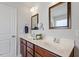 Bathroom vanity with double sinks, dark wood cabinets, and framed mirrors at 127 Lakemont Dr, Clayton, NC 27520
