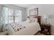 Comfortable bedroom with white bedding, patterned curtains, and a wood nightstand at 127 Lakemont Dr, Clayton, NC 27520