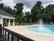 Community pool with an aqua fountain feature and several lounge chairs at 127 Lakemont Dr, Clayton, NC 27520