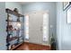 Bright entryway with hardwood floors, white door with sidelights, and stylish shelving at 127 Lakemont Dr, Clayton, NC 27520