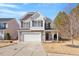 Charming two-story home featuring a well-manicured lawn, inviting front porch, and attached two-car garage at 127 Lakemont Dr, Clayton, NC 27520