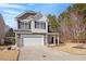 Beautiful home featuring a well-manicured lawn, inviting front porch, and attached two-car garage at 127 Lakemont Dr, Clayton, NC 27520