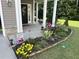 Charming front porch and garden with a curated bed of flowers at 127 Lakemont Dr, Clayton, NC 27520