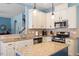 Bright kitchen with granite countertops and a kitchen island, connecting to the living room at 127 Lakemont Dr, Clayton, NC 27520