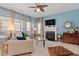 Inviting living room with a fireplace, lots of light, and stylish decor at 127 Lakemont Dr, Clayton, NC 27520