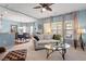 Spacious living room with a cozy fireplace, ceiling fan, and lots of natural light at 127 Lakemont Dr, Clayton, NC 27520