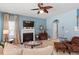 Inviting living room with a fireplace, ceiling fan, and lots of light at 127 Lakemont Dr, Clayton, NC 27520