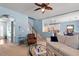 Cozy living room featuring plush seating, a ceiling fan, stairs, and hardwood flooring at 127 Lakemont Dr, Clayton, NC 27520
