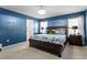 Tranquil main bedroom featuring dark blue walls, and a large bed with decorative pillows at 127 Lakemont Dr, Clayton, NC 27520