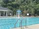 Community swimming pool featuring clear blue water, a mushroom water feature, and ample seating for residents to enjoy at 127 Lakemont Dr, Clayton, NC 27520