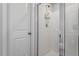 Standing shower featuring tiled walls, glass door and white door on the side at 127 Lakemont Dr, Clayton, NC 27520