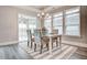 Bright dining room with large windows, modern chandelier, and stylish chairs at 129 Oban Dr, Homesite 150, Sanford, NC 27330