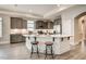 Modern kitchen featuring gray cabinets, stainless steel appliances, a large island, and bar stool seating at 129 Oban Dr, Homesite 150, Sanford, NC 27330