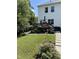 Beautiful backyard with a wooden deck, lush landscaping, a well-maintained lawn, and a pathway at 13 Piccadilly Ct, Durham, NC 27713