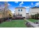 Large backyard with a spacious deck, a well-kept lawn, and mature trees provides an excellent outdoor space at 13 Piccadilly Ct, Durham, NC 27713