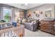 Neutral Bedroom features a crib, daybed, dresser, and window offering natural light at 13 Piccadilly Ct, Durham, NC 27713