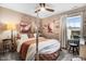Bright bedroom showcases a four-poster bed, art, and large window with natural light at 13 Piccadilly Ct, Durham, NC 27713