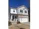Well-maintained two-story home with stone accents, a covered front porch, and a two-car garage at 13 Piccadilly Ct, Durham, NC 27713