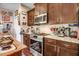 Well-equipped kitchen featuring wooden cabinets, stainless steel appliances, and granite countertops at 13 Piccadilly Ct, Durham, NC 27713