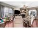 Cozy living room with a fireplace, hardwood floors, and large windows at 13 Piccadilly Ct, Durham, NC 27713