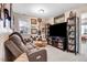 Cozy living room area featuring comfortable seating, display cases, and a collection of decorative items at 13 Piccadilly Ct, Durham, NC 27713