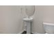 Small bathroom with a pedestal sink, toilet, and oval mirror at 132 Paper Birch Way, Fuquay Varina, NC 27526