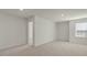 Spacious bedroom with neutral carpeting and a large window for natural light at 132 Paper Birch Way, Fuquay Varina, NC 27526