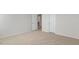 Large bedroom with neutral carpet and several doors at 132 Paper Birch Way, Fuquay Varina, NC 27526