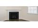 Close-up of a classic fireplace with a white mantel and hardwood-style flooring at 132 Paper Birch Way, Fuquay Varina, NC 27526